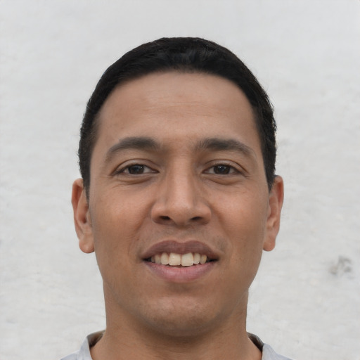 Joyful white young-adult male with short  black hair and brown eyes