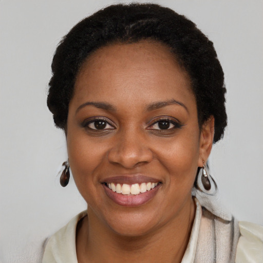 Joyful black young-adult female with short  black hair and brown eyes
