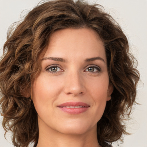 Joyful white young-adult female with medium  brown hair and green eyes