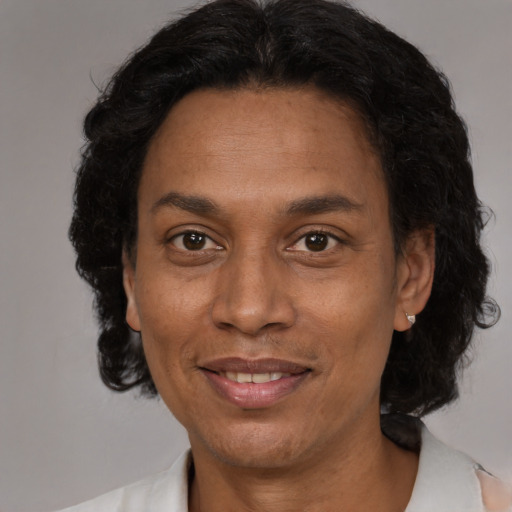 Joyful black adult female with medium  brown hair and brown eyes