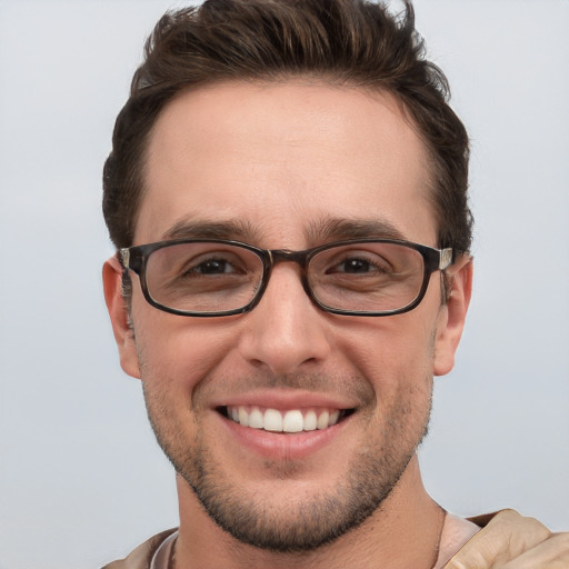 Joyful white young-adult male with short  brown hair and grey eyes