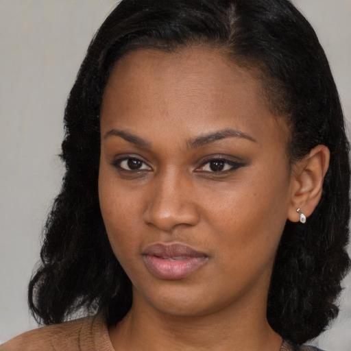 Neutral black young-adult female with medium  brown hair and brown eyes