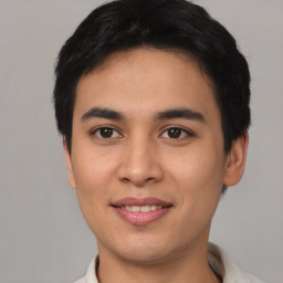 Joyful asian young-adult male with short  black hair and brown eyes