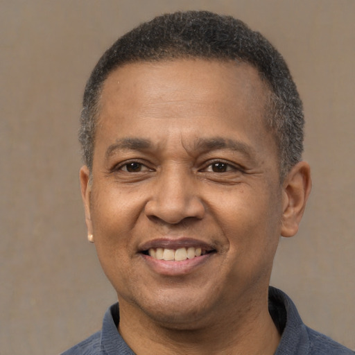 Joyful latino adult male with short  brown hair and brown eyes