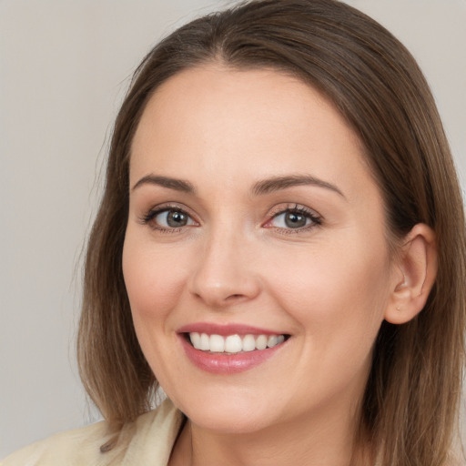 Joyful white young-adult female with long  brown hair and brown eyes