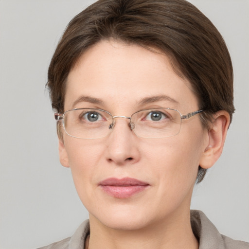 Joyful white adult female with short  brown hair and grey eyes