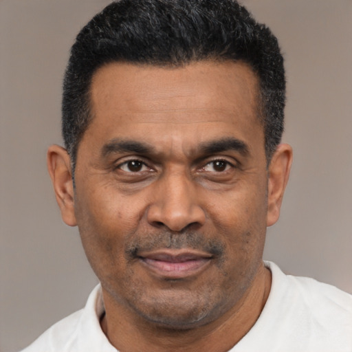 Joyful latino adult male with short  black hair and brown eyes