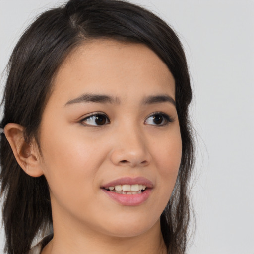 Joyful asian young-adult female with long  brown hair and brown eyes