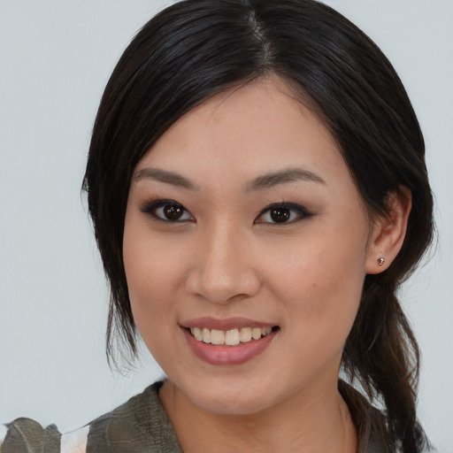 Joyful asian young-adult female with medium  brown hair and brown eyes