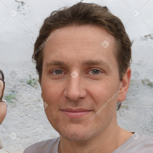 Joyful white adult male with short  brown hair and brown eyes