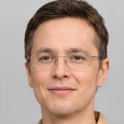 Joyful white adult male with short  brown hair and grey eyes