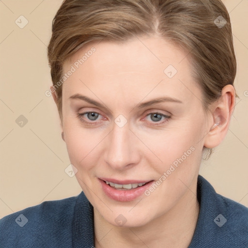 Joyful white young-adult female with short  brown hair and blue eyes