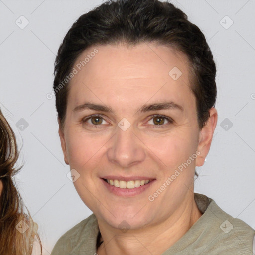 Joyful white adult female with medium  brown hair and brown eyes