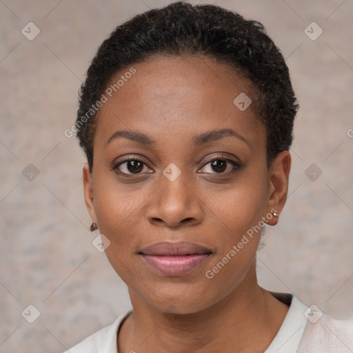 Joyful black young-adult female with short  black hair and brown eyes