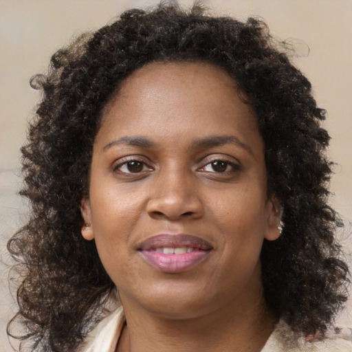 Joyful black young-adult female with medium  brown hair and brown eyes