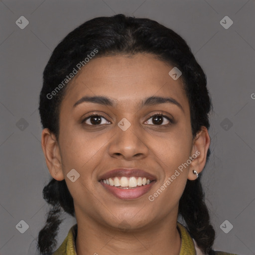 Joyful black young-adult female with long  brown hair and brown eyes