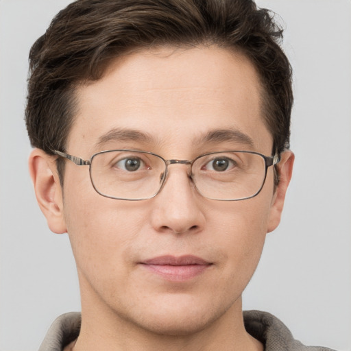 Joyful white adult male with short  brown hair and grey eyes