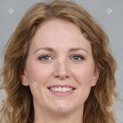 Joyful white adult female with long  brown hair and brown eyes