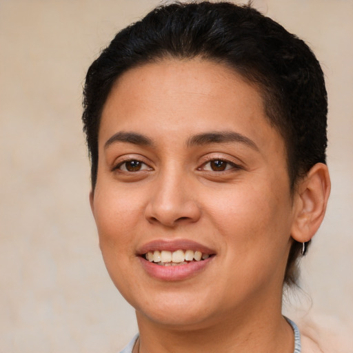 Joyful latino young-adult female with short  brown hair and brown eyes