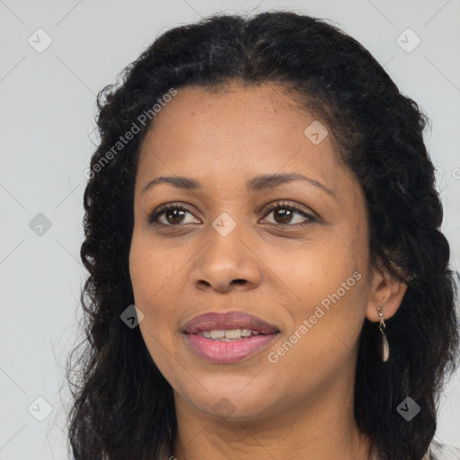 Joyful black adult female with long  brown hair and brown eyes