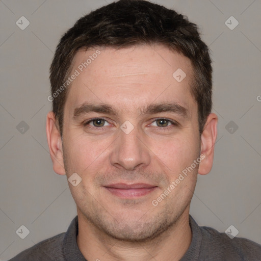 Joyful white adult male with short  brown hair and brown eyes