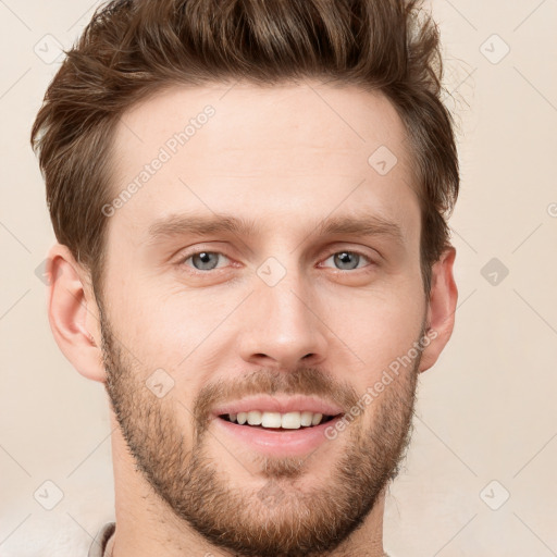 Joyful white young-adult male with short  brown hair and grey eyes