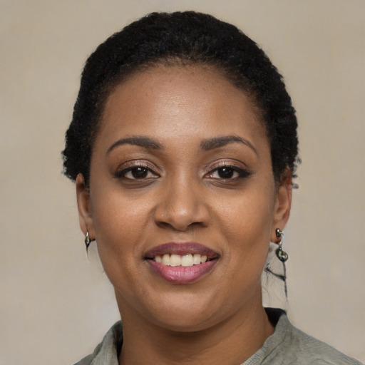 Joyful latino young-adult female with short  black hair and brown eyes