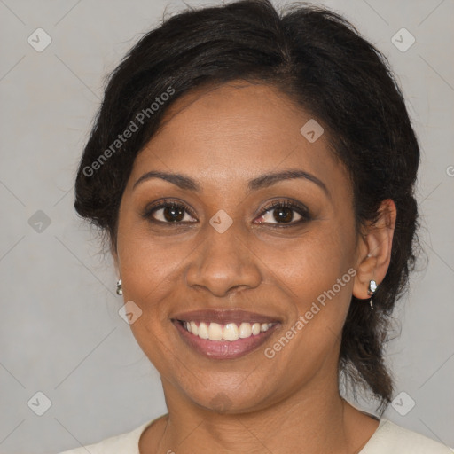 Joyful black adult female with medium  brown hair and brown eyes