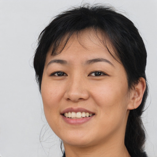 Joyful asian young-adult female with medium  brown hair and brown eyes