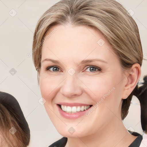 Joyful white young-adult female with medium  brown hair and blue eyes