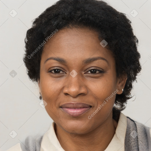 Joyful black adult female with short  brown hair and brown eyes