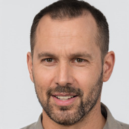 Joyful white adult male with short  brown hair and brown eyes