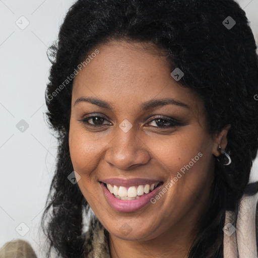 Joyful black young-adult female with long  brown hair and brown eyes