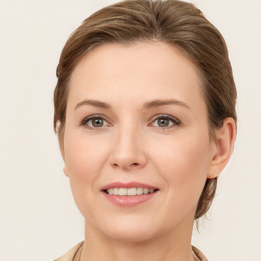 Joyful white young-adult female with medium  brown hair and grey eyes