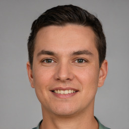 Joyful white young-adult male with short  brown hair and grey eyes