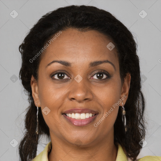 Joyful black adult female with medium  brown hair and brown eyes