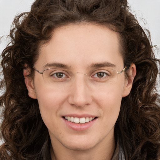 Joyful white young-adult female with long  brown hair and green eyes