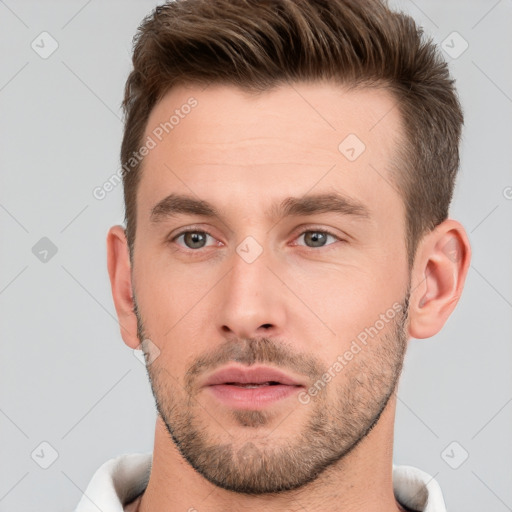 Neutral white young-adult male with short  brown hair and brown eyes