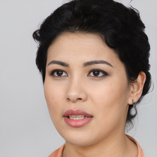Joyful latino young-adult female with medium  black hair and brown eyes