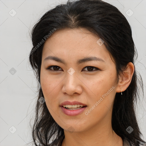 Joyful asian young-adult female with long  brown hair and brown eyes