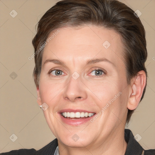 Joyful white adult female with medium  brown hair and brown eyes