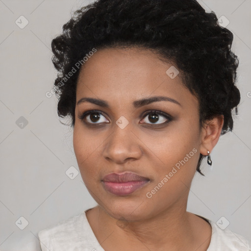 Joyful black young-adult female with short  black hair and brown eyes