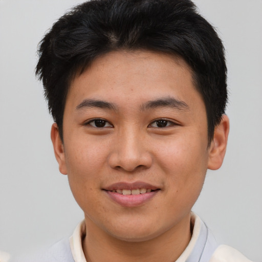 Joyful asian young-adult male with short  brown hair and brown eyes