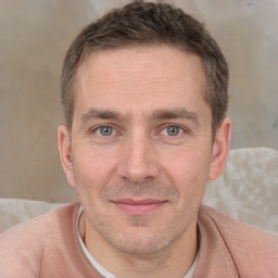 Joyful white adult male with short  brown hair and brown eyes