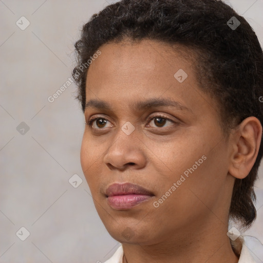 Joyful black young-adult female with short  brown hair and brown eyes