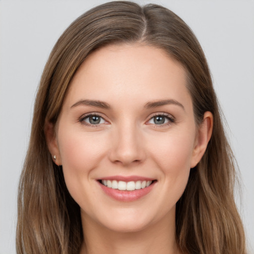 Joyful white young-adult female with long  brown hair and grey eyes