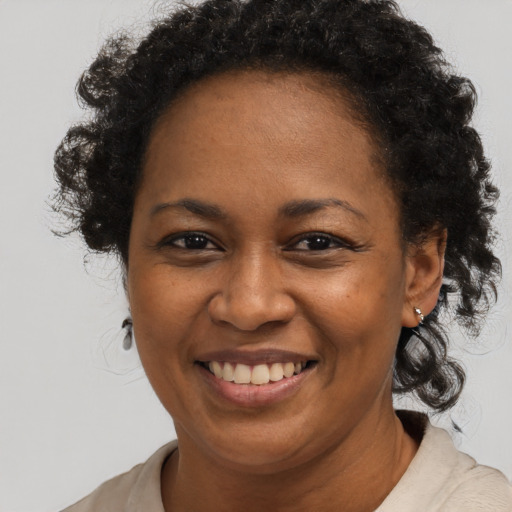 Joyful black adult female with short  brown hair and brown eyes