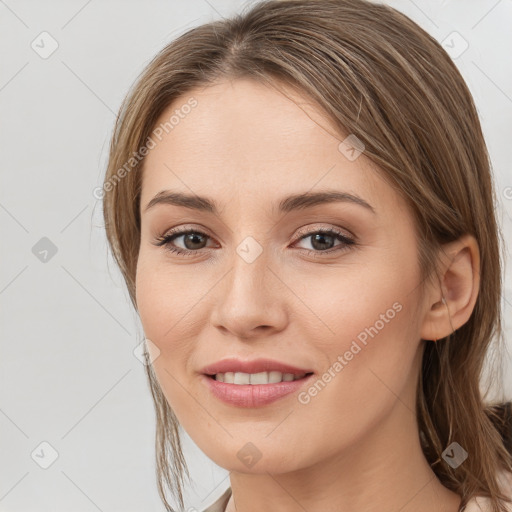 Joyful white young-adult female with medium  brown hair and grey eyes