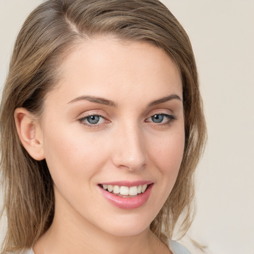 Joyful white young-adult female with medium  brown hair and blue eyes