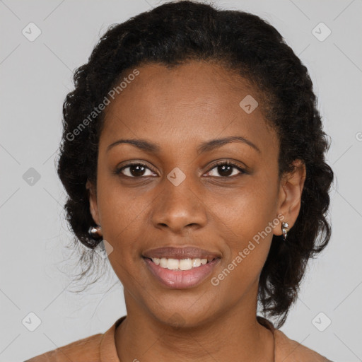 Joyful black young-adult female with medium  brown hair and brown eyes